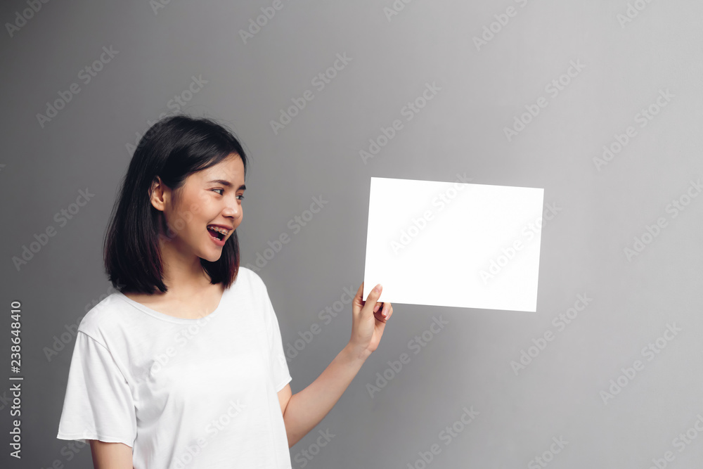 Young woman holding a blank poster for text on a white background. Young woman holding a blank poster for text on a white background.