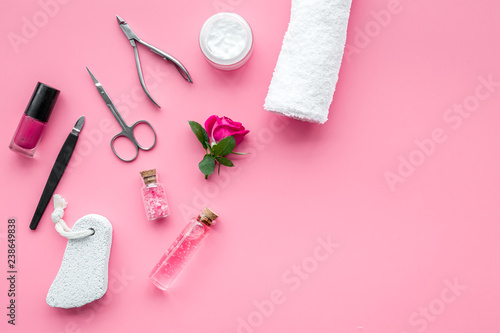 tools for manicure with spa salt and rose on pink background top view mockup