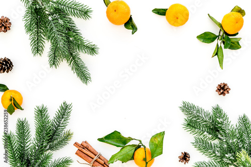 Fototapeta Naklejka Na Ścianę i Meble -  branch of mandarins, fir tree and cinnamon for New Year and Christmas celebration on white background top view mockup