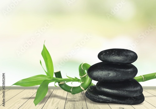 Zen basalt stones and leaves on desk