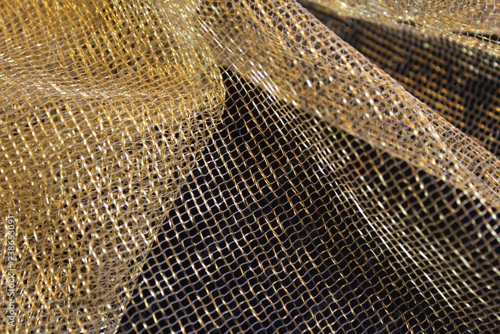 Fototapeta premium Gold colored mesh fabric