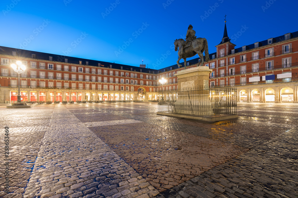 Madrid travel destination. Statue of Philip III on Plaza Mayor. Historical building in Plaza Mayor area at Madrid, Spain.
