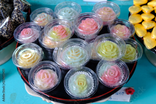 Thai color full dessert in rose pattern in black dish. This desert made from Koh Kret, Nonthaburi, December 2018