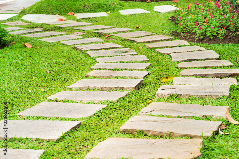 Stone path in park on green grass Stone path in park on green grass