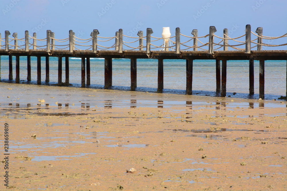 wooden bridge on the sea in a resort area