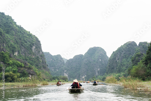 TamCoc, NinhBinh/VietNam, November 25,2017 :  Tourists traveling in traditional bamboo boats along the Ngo Dong River of the Tam Coc, Ninh Binh, Vietnam.
