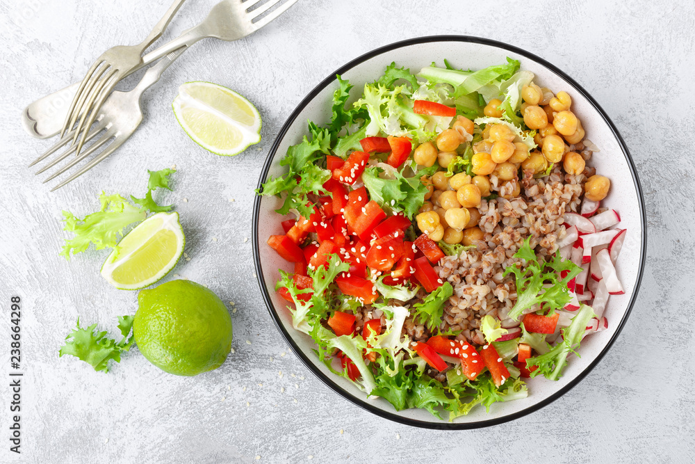 Healthy and delicious bowl with buckwheat and salad of chickpea, fresh pepper and lettuce leaves. Dietary balanced plant-based food. Vegan and vegetarian dish. Top view. Flat lay Healthy and delicious bowl with buckwheat and salad of chickpea, fresh pepper and lettuce leaves. Dietary balanced plant-based food. Vegan and vegetarian dish. Top view. Flat lay