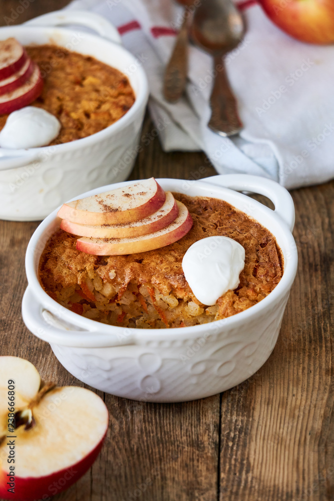 Rice casserole with apples and carrots on a wooden background Rice casserole with apples and carrots on a wooden background