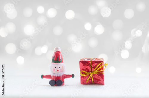 Santa claus and red gift box with shiny light for Christmas decoration background