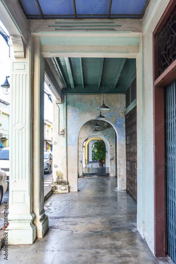 long corridor between  columns and arches, chino-portuguese style, Phuket Thailand