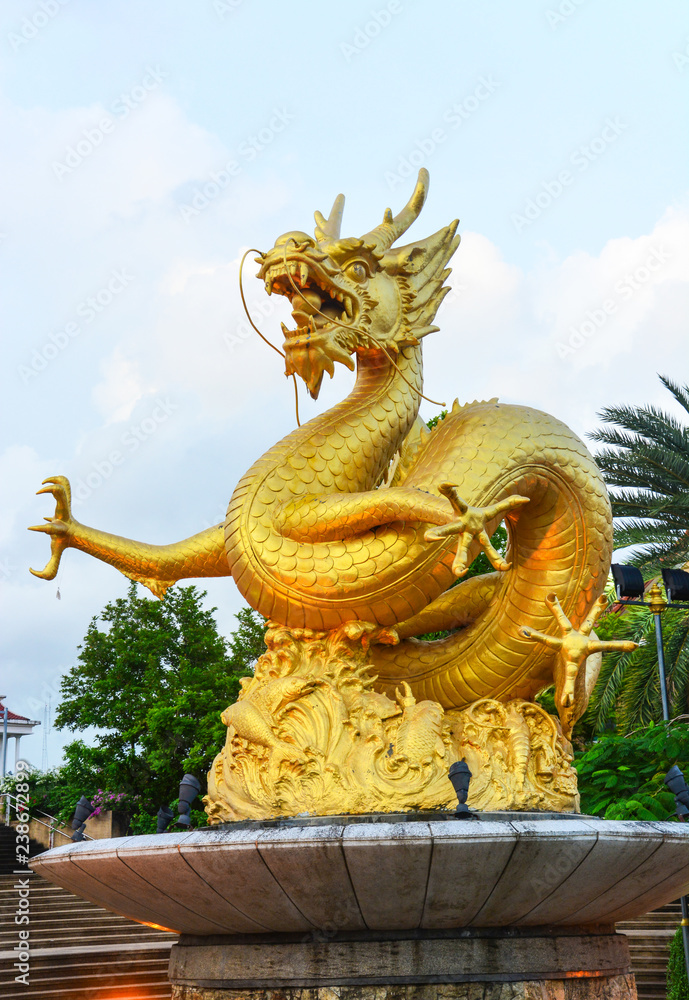 Fototapeta premium gold dragon scrulpture at public park, Phuket Thailand