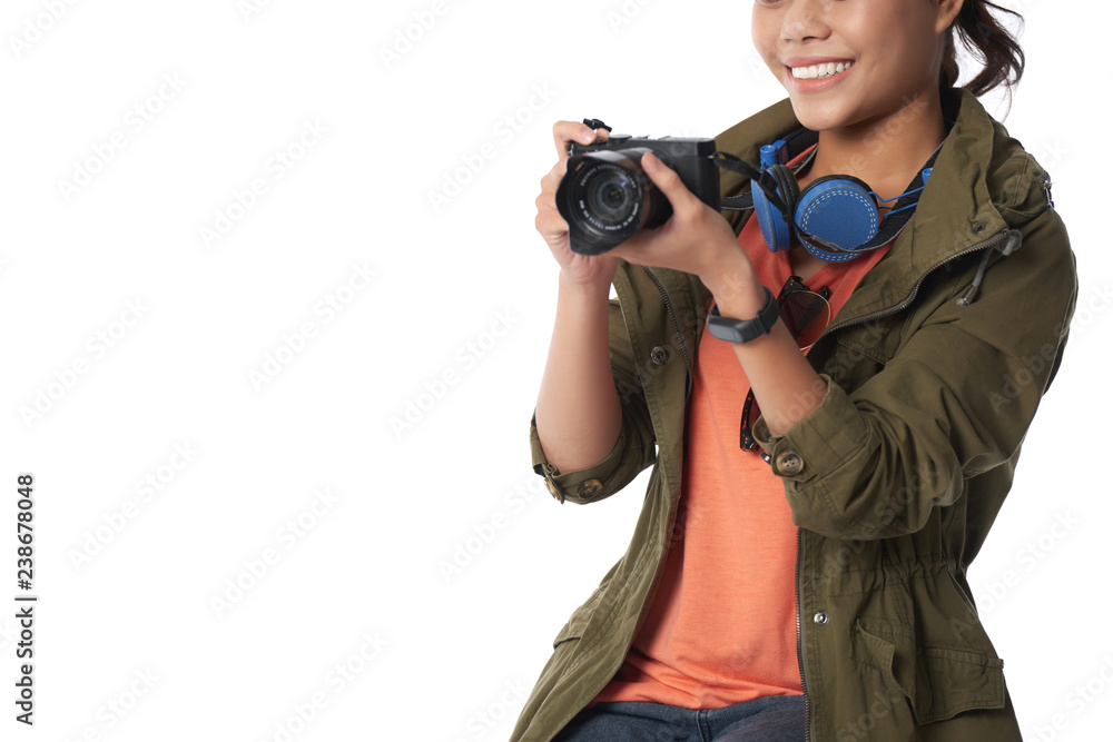Obraz premium Cropped image of cheerful young woman taking photos during her vacation