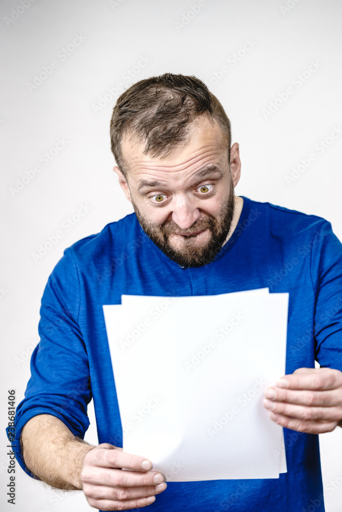 Shocked man looking at documents Shocked man looking at documents