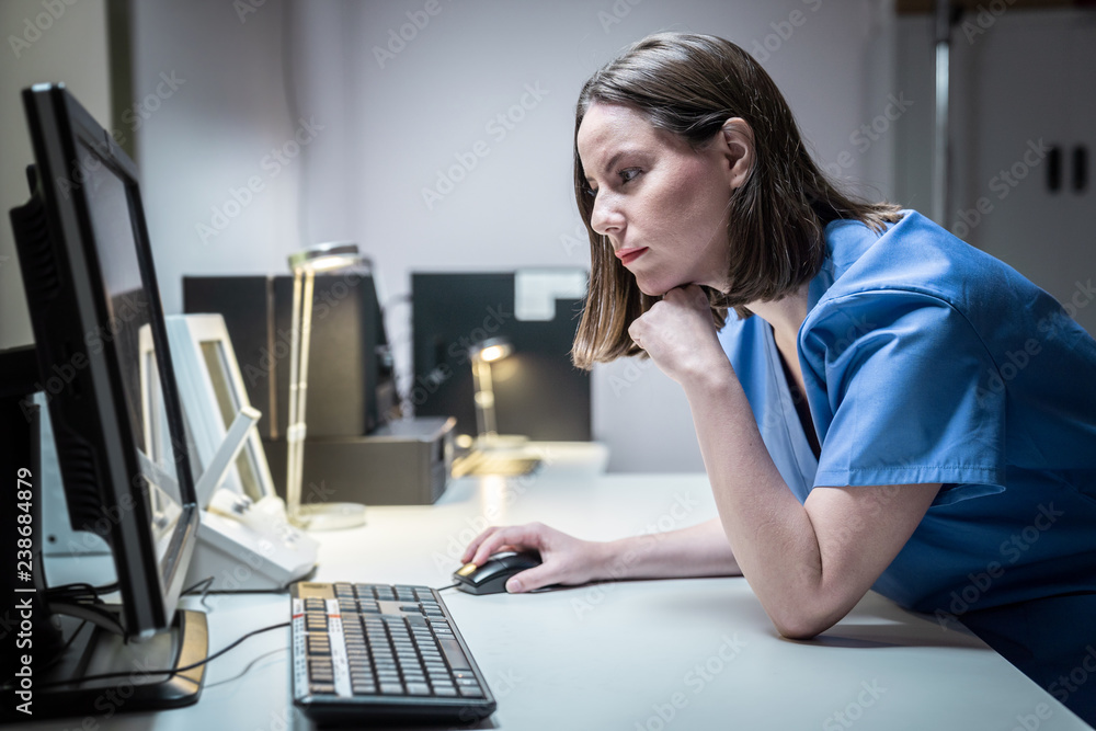 Health Care Worker In Clinic With Computer And Equipment Health Care Worker In Clinic With Computer And Equipment