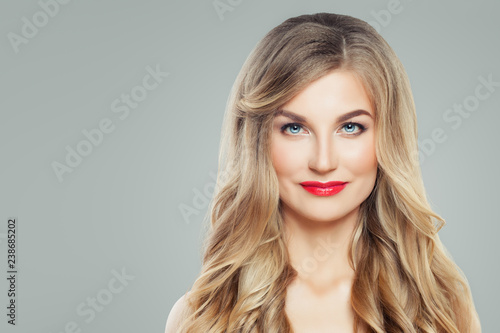 Perfect woman face. Blonde woman with long wavy hair and clear skin. Facial treatment and cosmetology