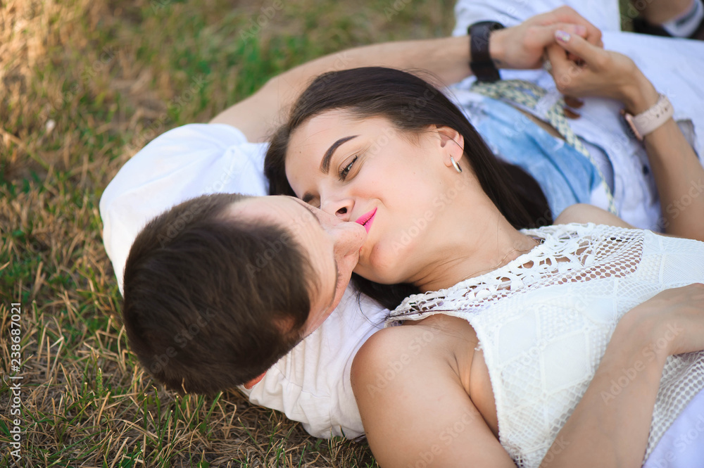 Portrait of the young adorable couple in love who lying head to head outdoors Portrait of the young adorable couple in love who lying head to head outdoors