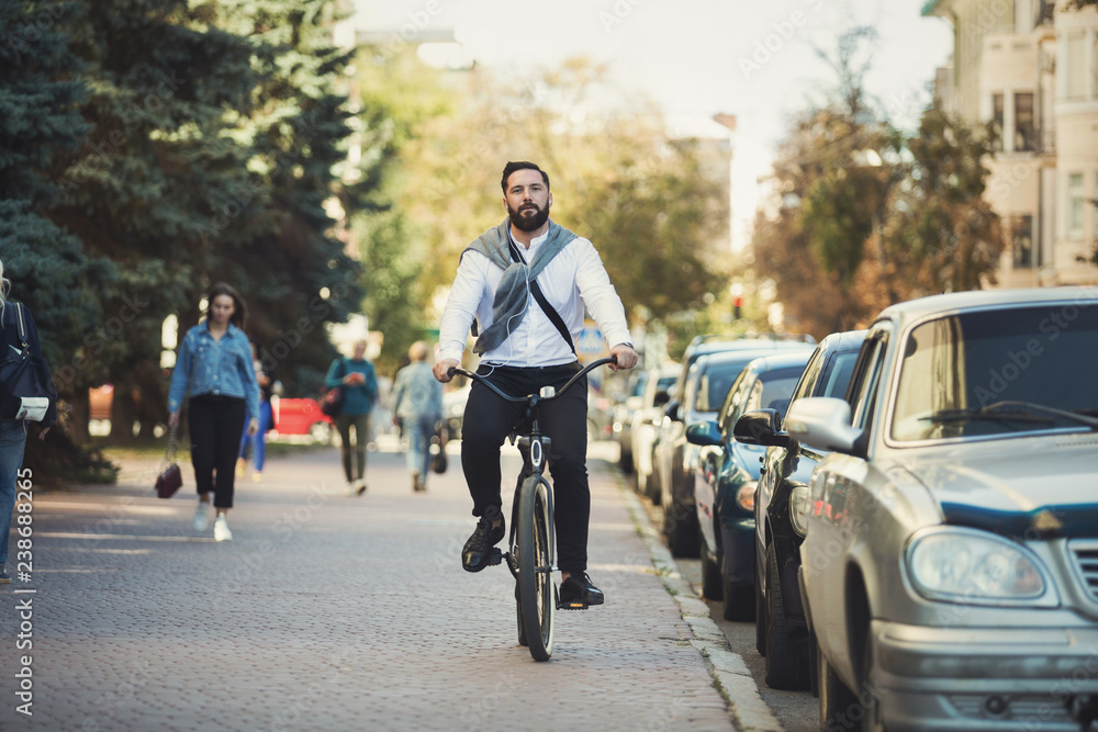 Young businessman going to work by bicycle