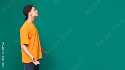 Arrogant teen guy over background with copy space