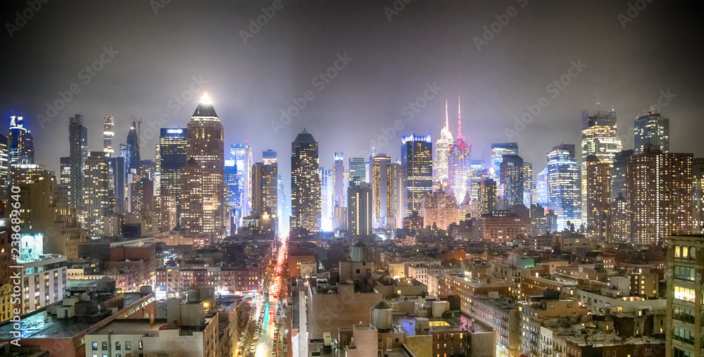 Naklejka premium Midtown Manhattan aerial view at night as seen from Hell's Kitchen rooftop