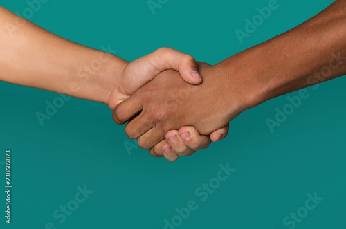 Handshake of afro-american and caucasian teenager hands