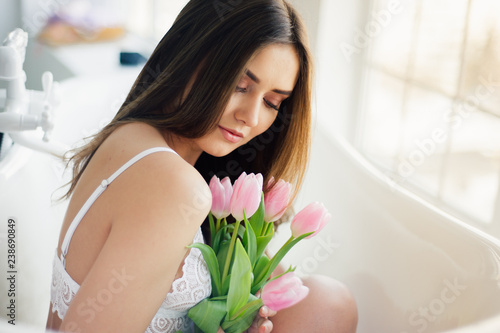 Portrait of beautiful woman with tulip bouquet . Inspiration of spring. photo