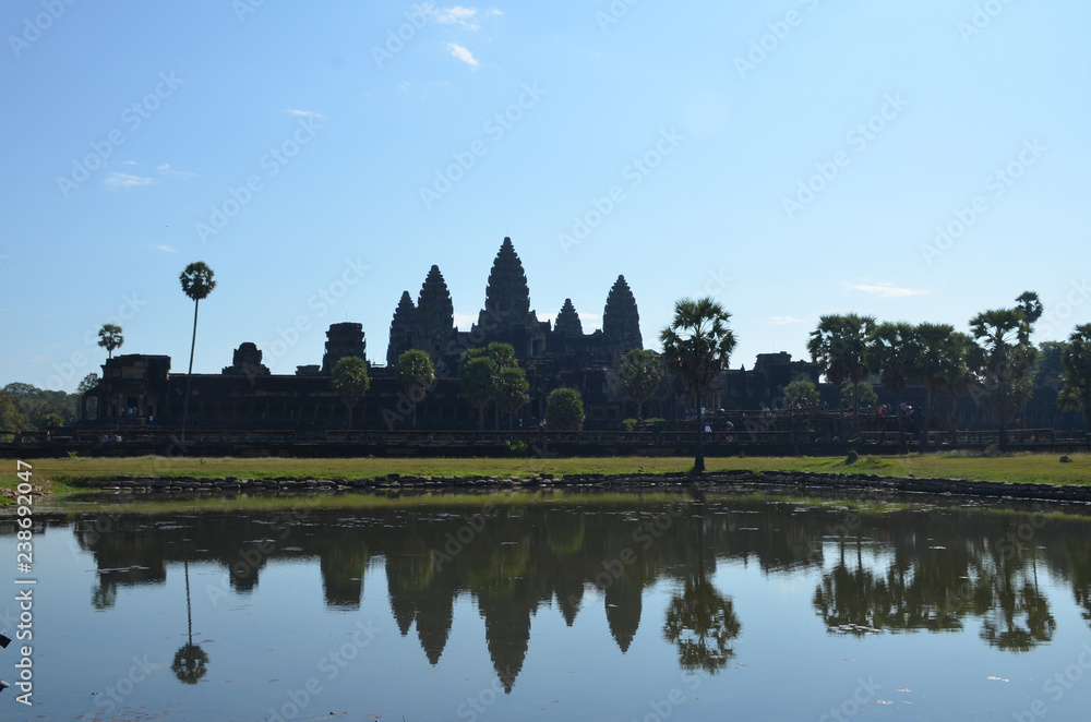 The Angkor Wat temple with five towers is reflected in the lake. Angkor, Cambodia.