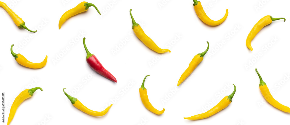 One red chilli pepper among yellow on white background. One red chilli pepper among yellow on white background.
