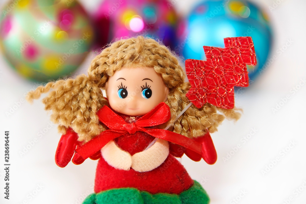 New Year's little doll fairy in a festive Christmas red dress New Year's little doll fairy in a festive Christmas red dress