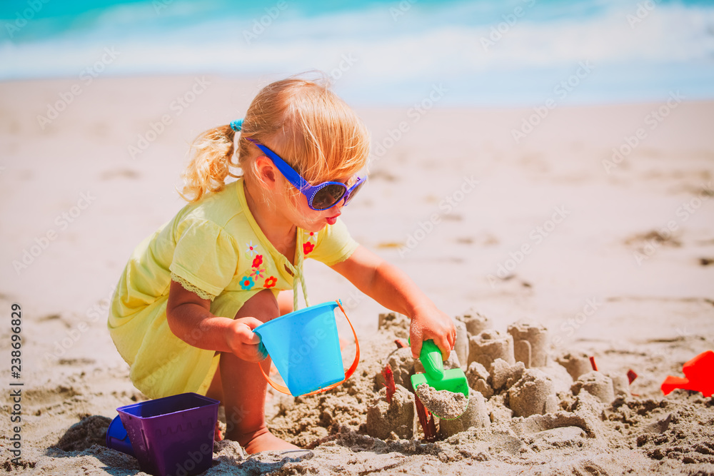 cute little girl play with sand on beach cute little girl play with sand on beach