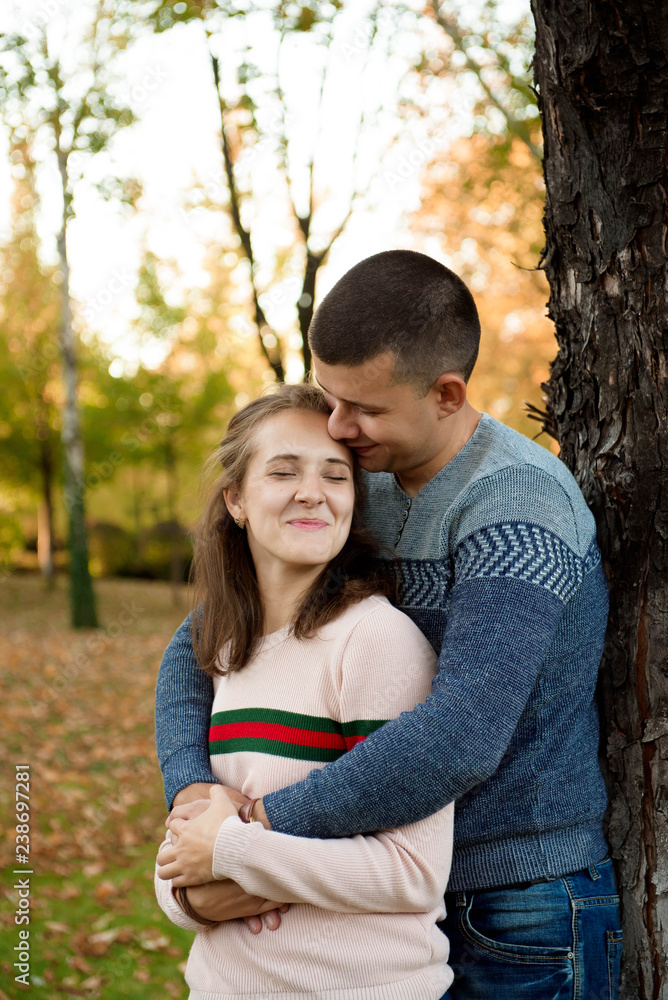 Happy Couple in Autumn Park. Fall. Young Family Having Fun Happy Couple in Autumn Park. Fall. Young Family Having Fun