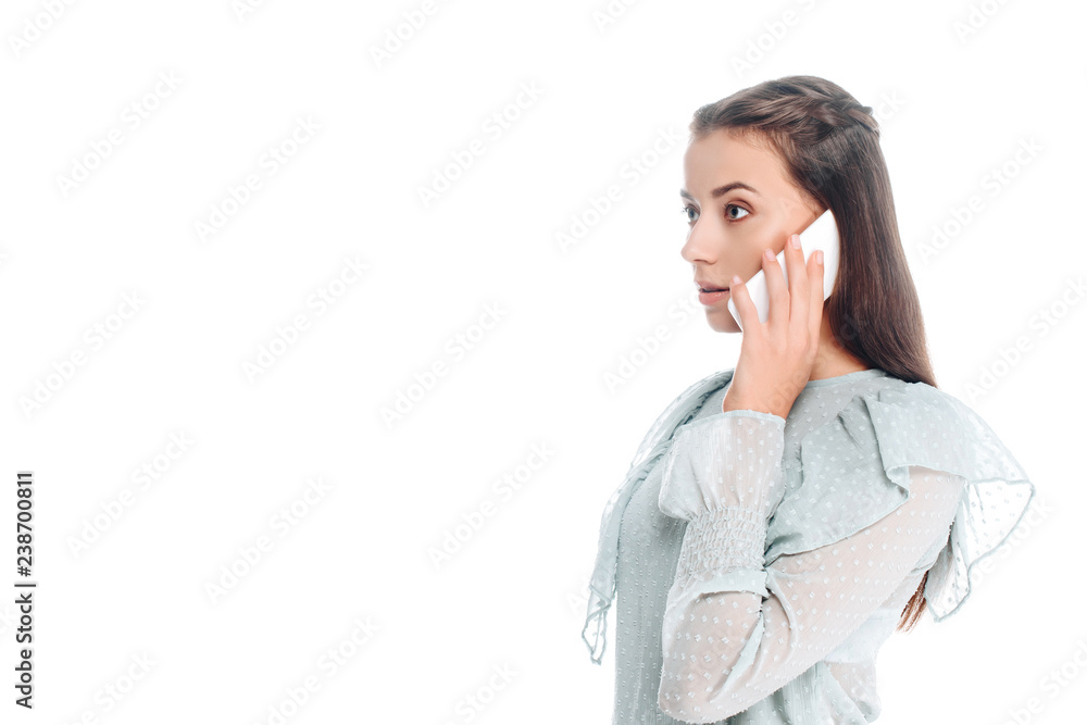 side view of young woman talking on smartphone isolated on white side view of young woman talking on smartphone isolated on white