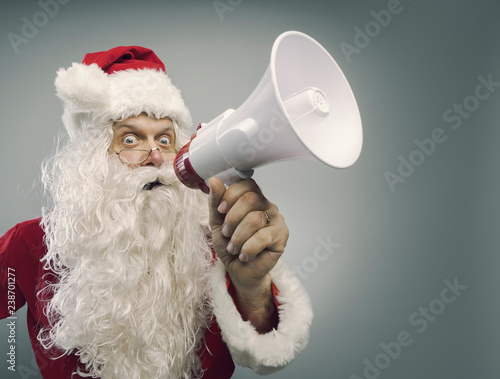 Excited Santa shouting a message with a megaphone