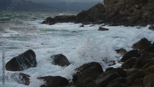 coastal waves hit the rocks and splatter photo