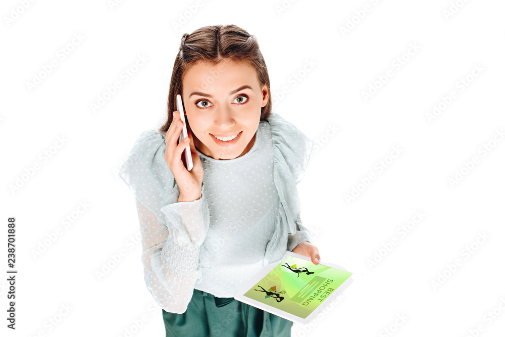 high angle view of smiling woman with tablet talking on smartphone isolated on white high angle view of smiling woman with tablet talking on smartphone isolated on white
