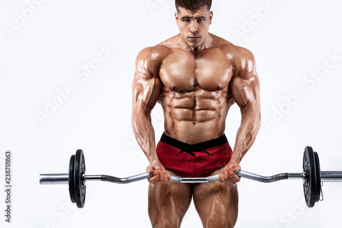 Brutal strong muscular bodybuilder athletic man pumping up muscles with barbell on white background. Workout bodybuilding concept. Copy space for sport nutrition ads.
