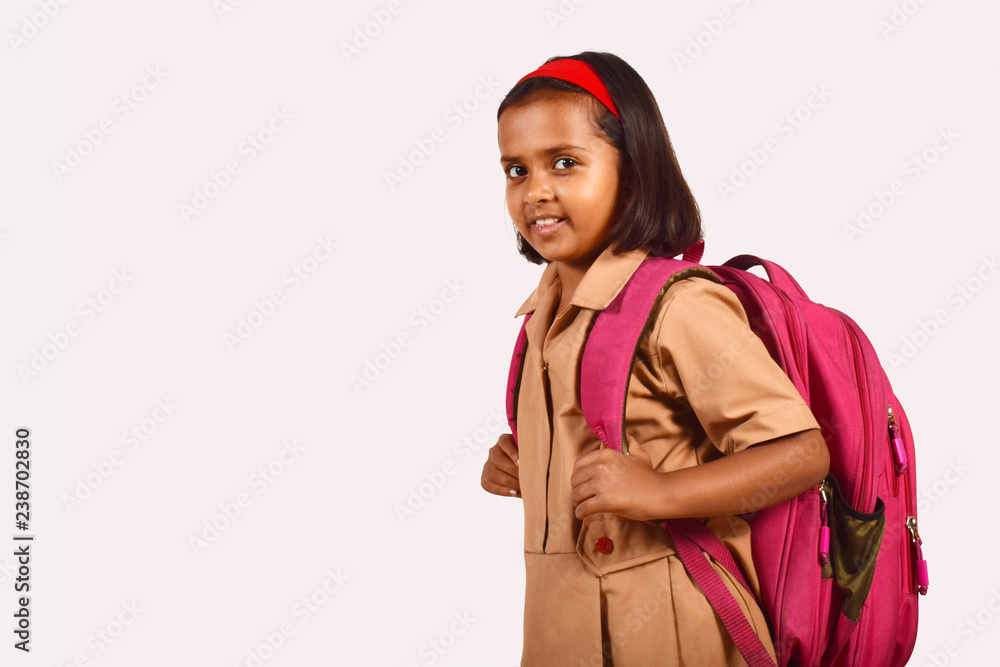 Little girl in school uniform and bag posing in front of camera. Pune,  Maharashtra Photos | Adobe Stock