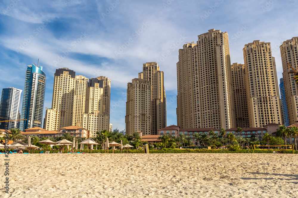 View of the high-rise buildings of Dubai from the beach. Dubai Marina district. 2018. View of the high-rise buildings of Dubai from the beach. Dubai Marina district. 2018.