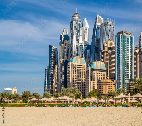 View of the high-rise buildings of Dubai from the beach. Dubai Marina district. 2018.