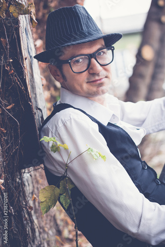 Portrait of smiling well dressed man with fedora hat. photo