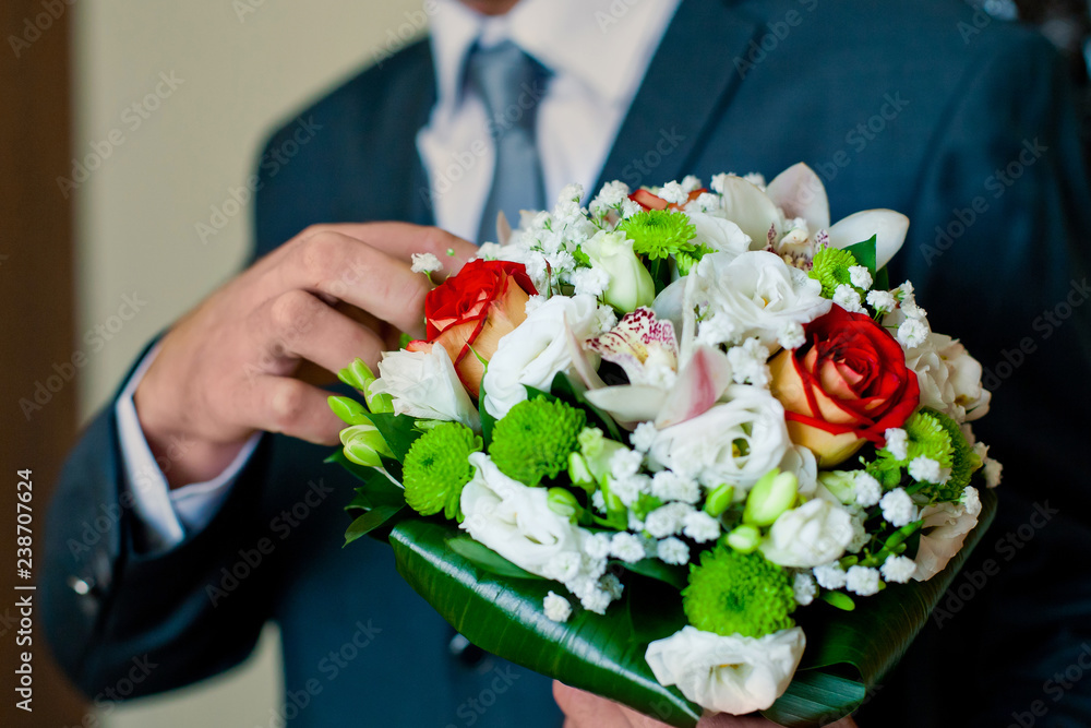 Wedding bouquet of flowers. Wedding flowers of the bride in the hands of the groom. Wedding bouquet of flowers. Wedding flowers of the bride in the hands of the groom.