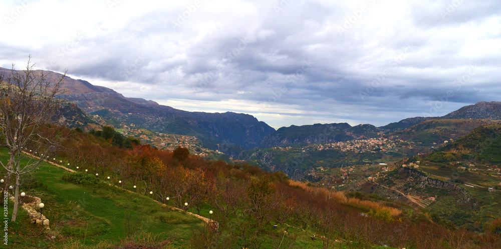 landscape in the mount Lebanon during fall with a colorful orchard in foreground