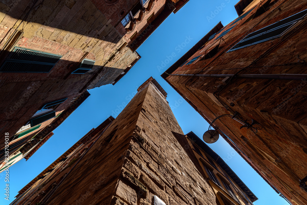 View upwards from the ground level into the sky in Luca old town narrow streets View upwards from the ground level into the sky in Luca old town narrow streets