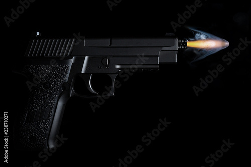 shot from a handgun with a bullet in motion, fire and smoke
