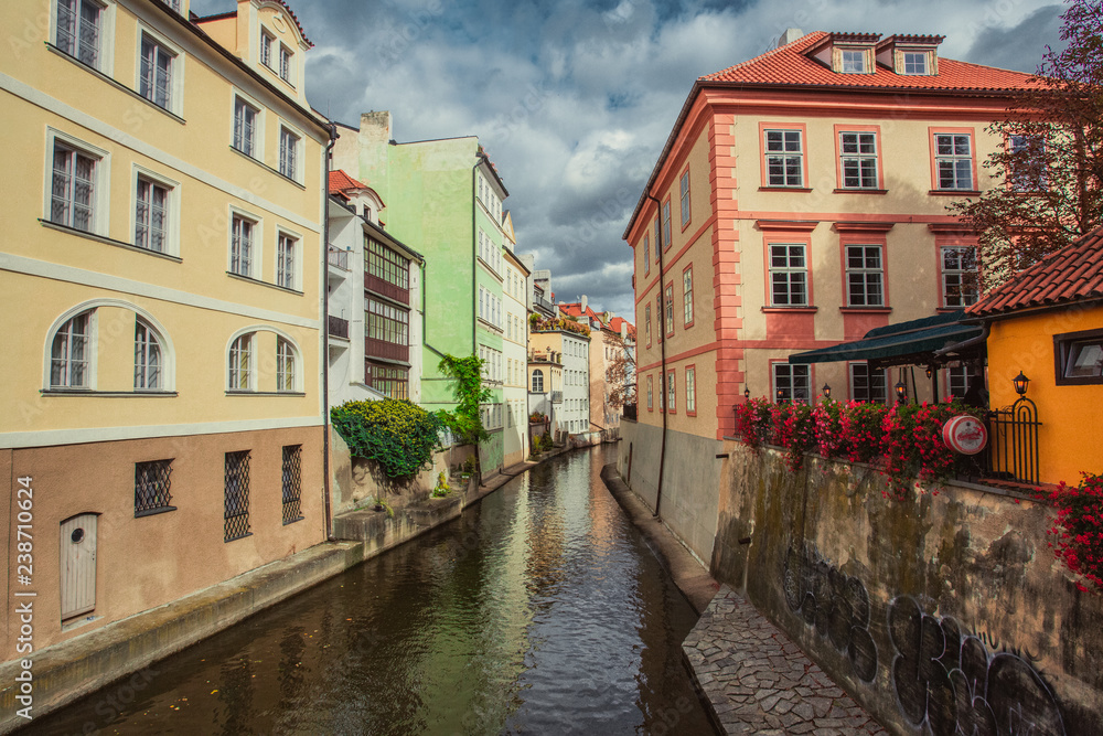 Czech Republic, Prague, Certovka river, Devil's Channel, also called Little Prague Venice between Kampa island and Mala strana in Czech Republic with Historic Mill Wheel and boat