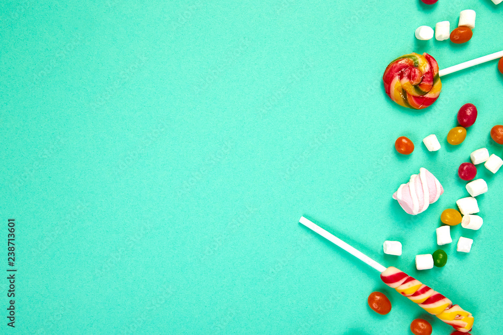 Colorful candies on pastel turquoise background. Flat lay Colorful candies on pastel turquoise background. Flat lay