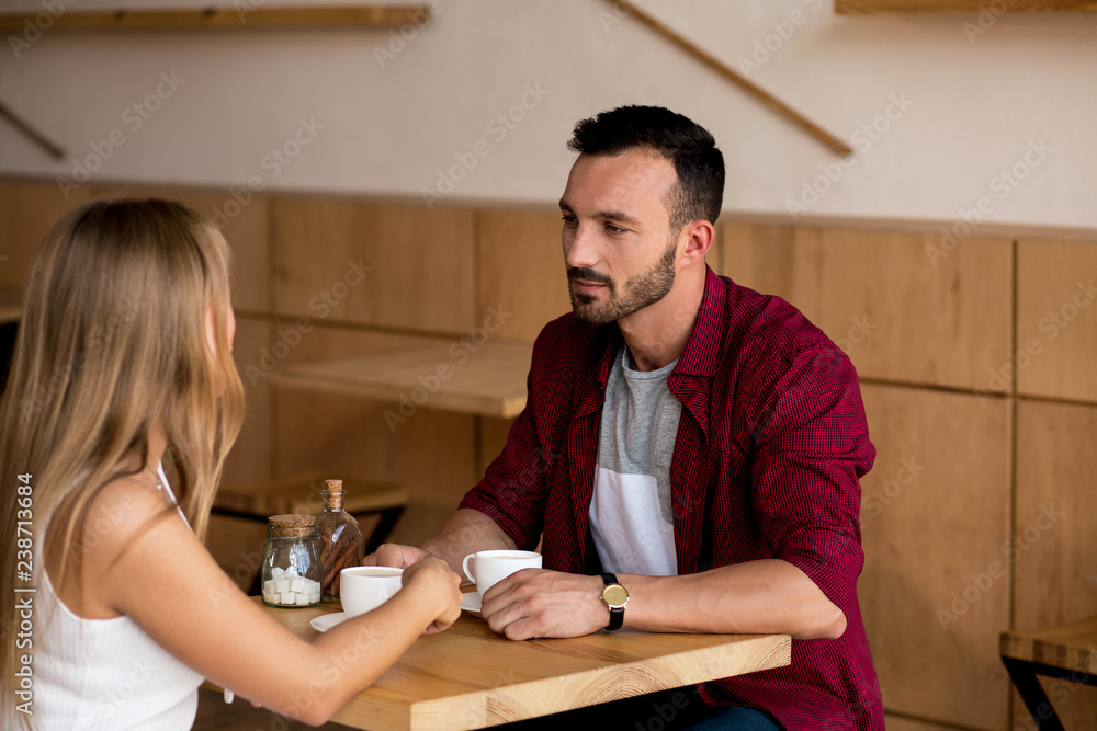 Cute couple having coffee together in cafe Cute couple having coffee together in cafe