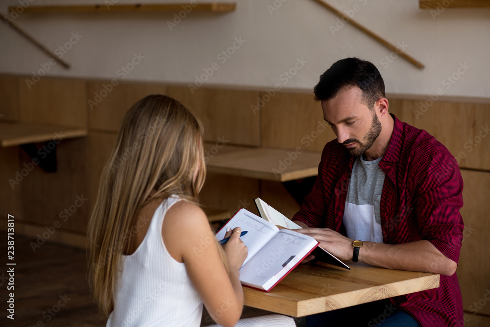 Beloved young couple making notes Beloved young couple making notes