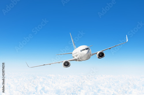 Airplane fly in the blue sky in below the clouds, with space for text.