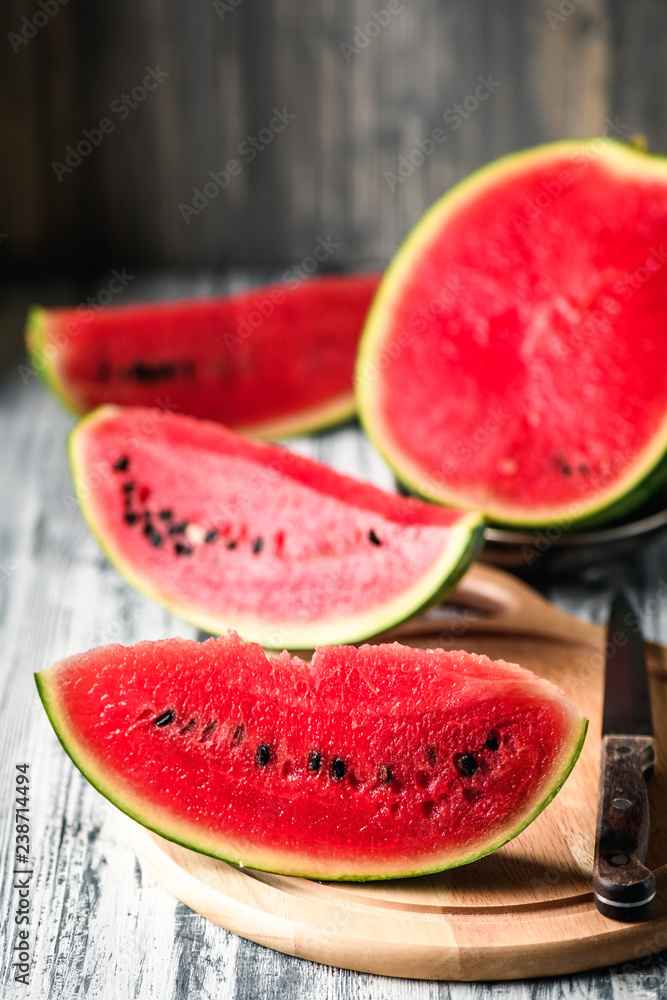 Watermelon on a rustic table. Pieces of red flesh close up Watermelon on a rustic table. Pieces of red flesh close up