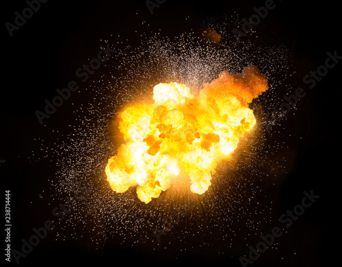 Realistic fiery explosion with sparks over a black background